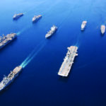 Arabian Gulf, May 24, 2003 - Amphibious Task Force-West (ATF-West), comprised of USS Bon Homme Richard (LHD-6), USS Boxer (LHD-4), USS Dubuque (LPD-8), USS Comstock (LSD-45), USS Anchorage (LSD-36), USS Pearl Harbor (LSD-52) and USS Cleveland (LPD-7), steam in formation with Military Sealift Command oiler USNS Guadalupe (T-AO 200). ATF-West deployed from San Diego, transporting Marines and their gear to Kuwait for further deployment into Iraq.